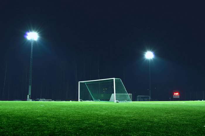 Soccer field at night with stadium lights