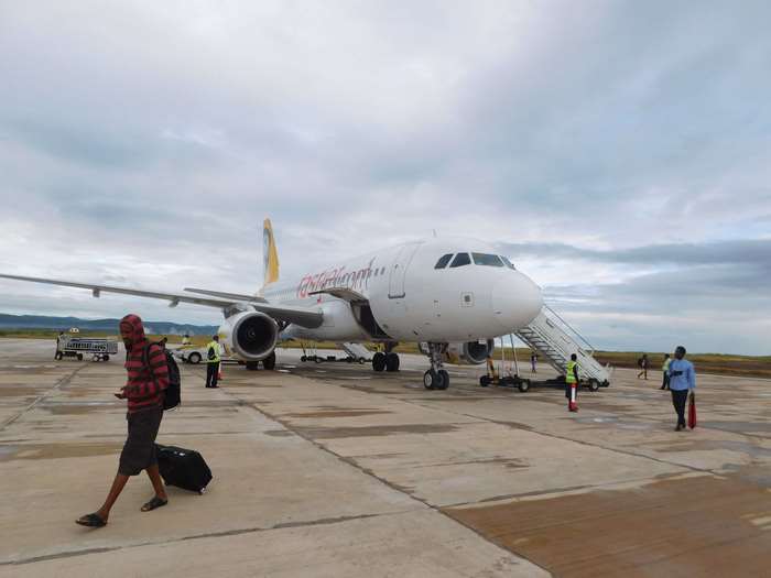 Airplane at airport with people