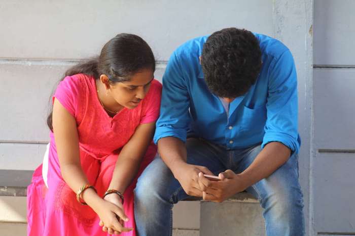 Indian Teen Boy and Girl Sitting Together