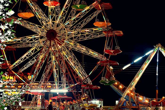 Ferris wheel and amusement rides at night