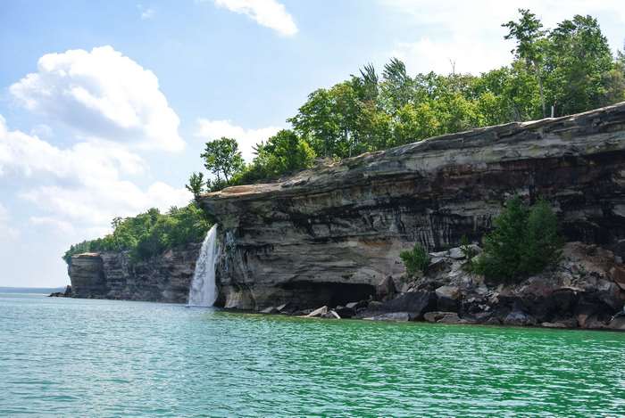 Waterfall cascading over Pictured Rocks cliffs into Lake Superior