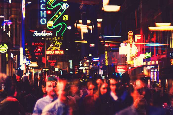 Street scene with neon signs and people