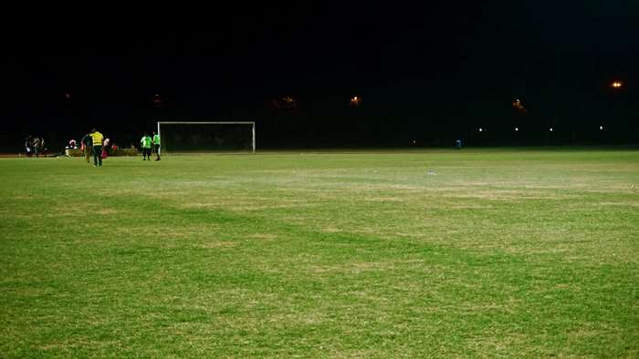 Soccer players on a field at night