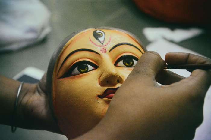 Painting a Durga idol's face