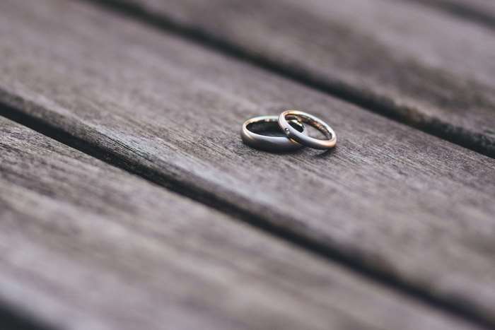 Two wedding rings on a wooden table