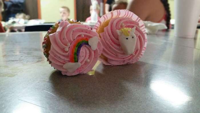 Pink cupcakes with rainbow and unicorn decorations