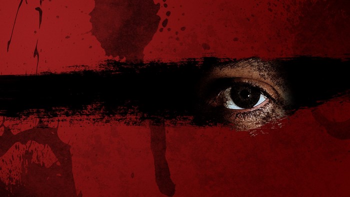 Close-Up of Eye Behind Dark Streak on Red Background
