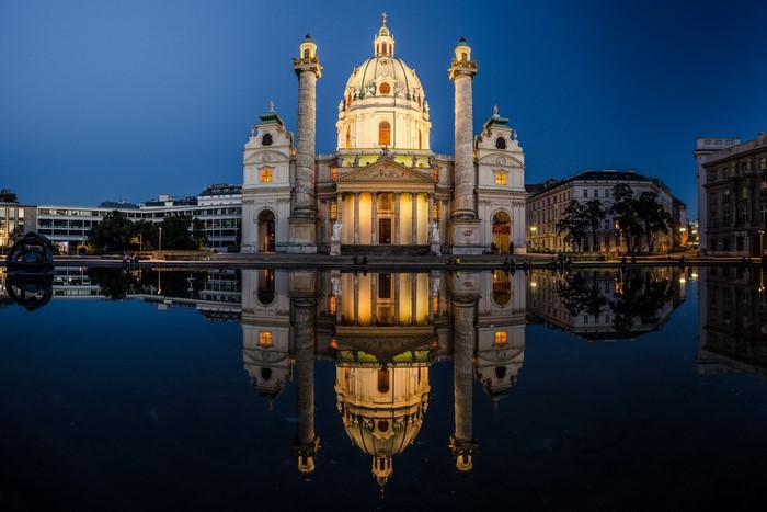 Karlskirche church reflected in water at dusk