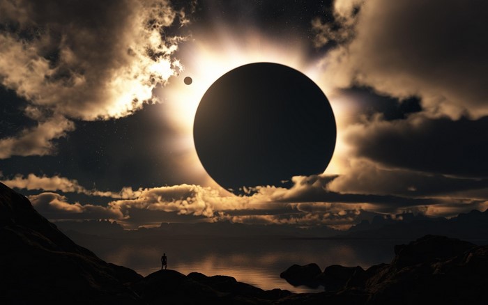 Solar eclipse with a lone figure on a rocky shore