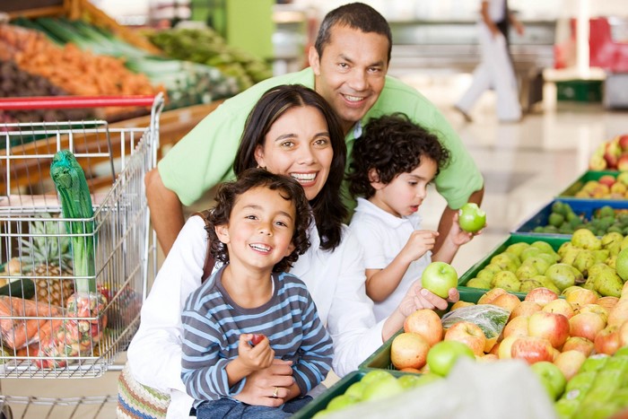 Family shopping for groceries in a supermarket