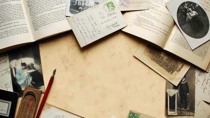 Vintage letters, postcards, photos, and pen on a table