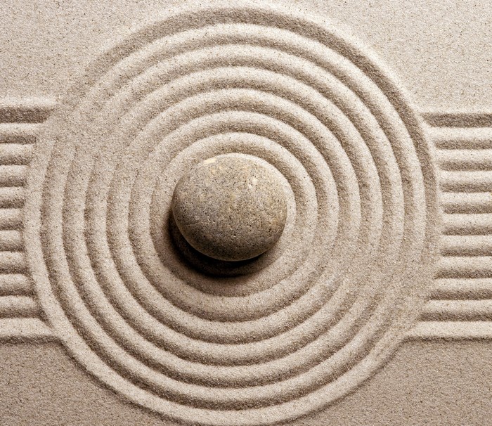 Zen garden with stone and sand ripples