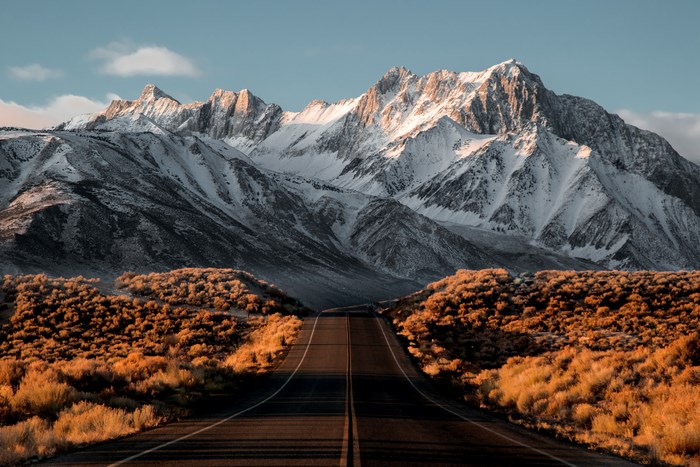 Road leading to snow-capped mountains