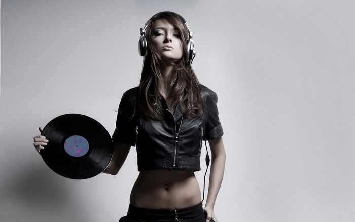 DJ girl with headphones holding a vinyl record