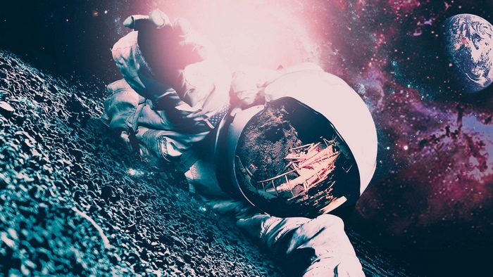 Astronaut on a rocky surface with Earth in the background