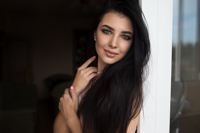 Woman with long black hair and blue eyes