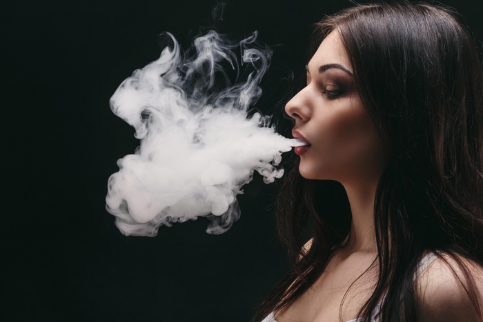 Woman exhaling smoke
