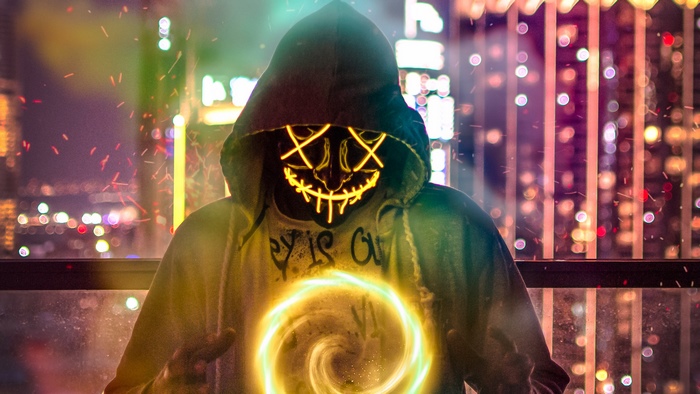 Person in a neon mask with a glowing portal