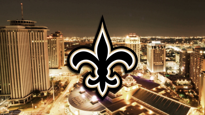 New Orleans Saints logo over city skyline at night