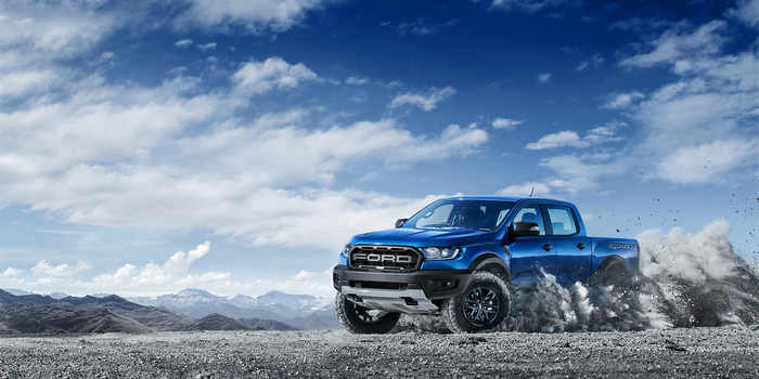 Blue Ford Ranger Raptor driving off-road
