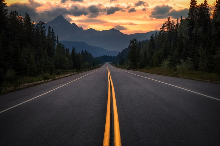 Road through mountains at sunset