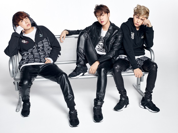 BTS members Suga, Jin, and V posing for Puma