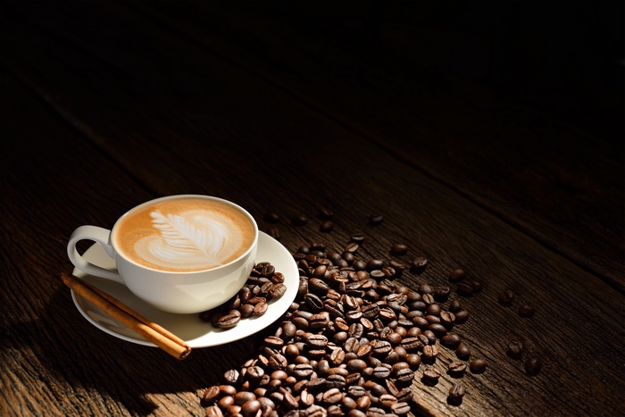 Cup of Coffee with Latte Art and Coffee Beans