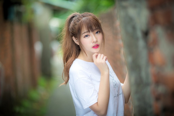 Asian Brunette Woman with Ponytail and Blue Eyes