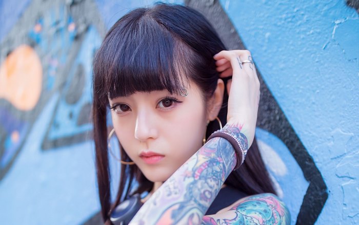 Asian girl with tattoos and piercings