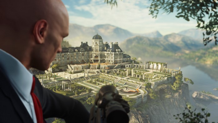 Agent 47 from Hitman 2 with sniper rifle overlooking a mansion