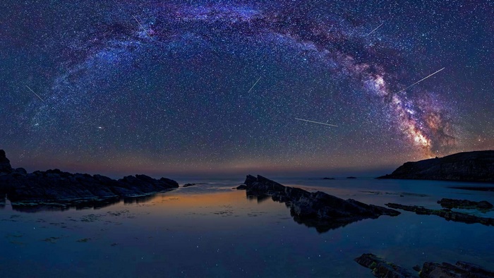Milky Way Arch over Rocky Coastline at Night