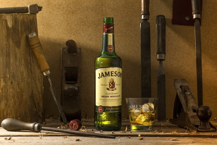 Jameson Irish Whiskey bottle and glass with woodworking tools