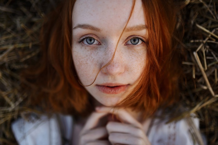 Close-Up Portrait of Freckled Redhead Girl with Blue Eyes