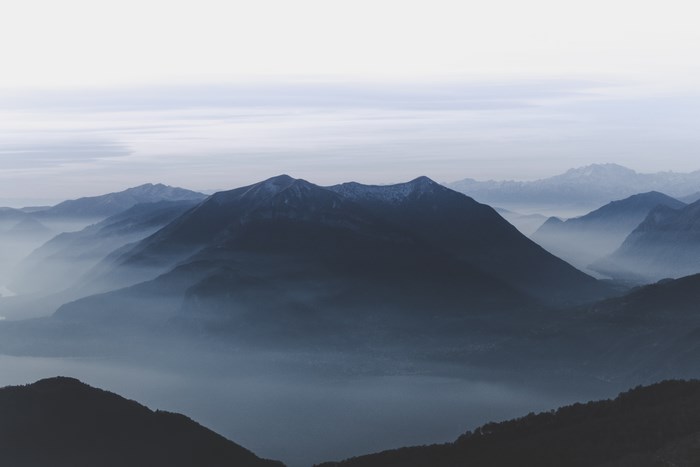 Misty mountain range with blue hues