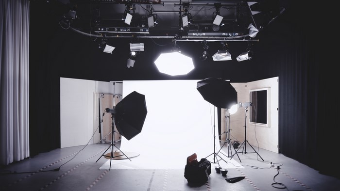 Photography studio with lighting equipment and backdrop