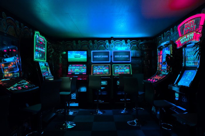 Neon-Lit Retro Arcade Machines in Dark Room