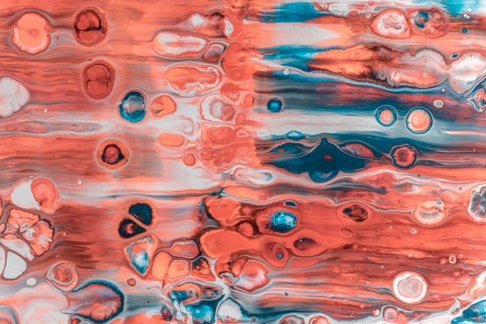Abstract paint pour with red, blue, and white colors