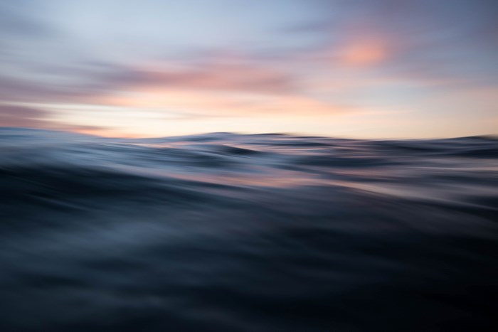 Abstract motion blur of ocean waves at sunset