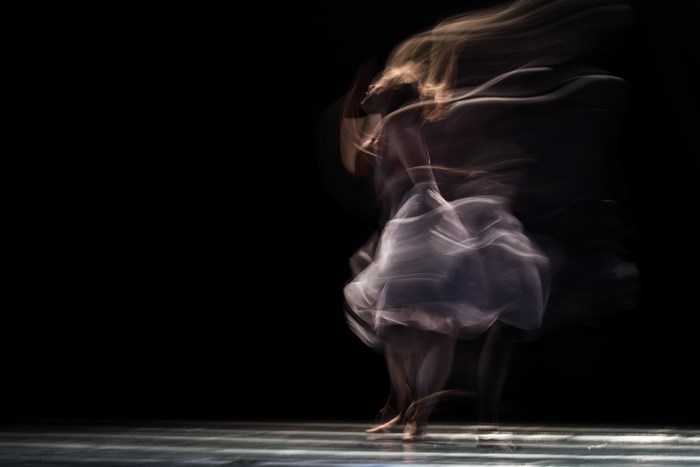 Female dancer in motion blur on stage