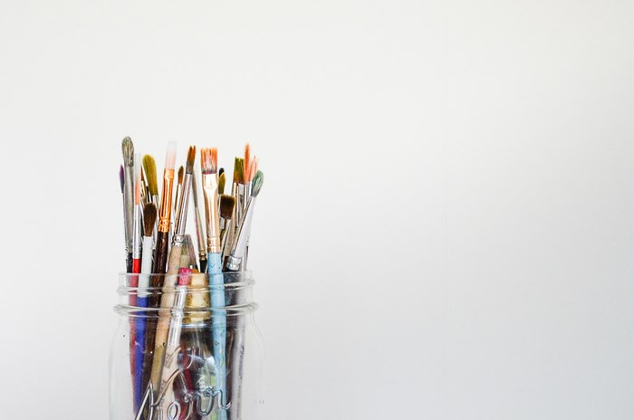 Paintbrushes in a glass jar