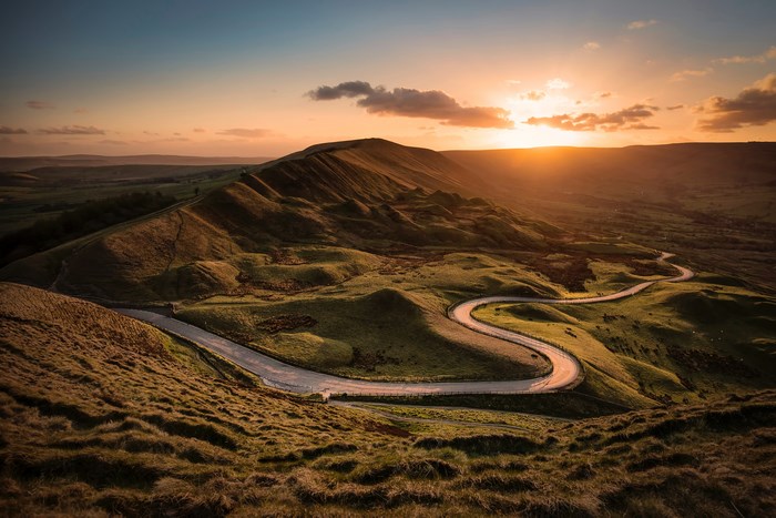 Winding road through Mam Tor hills at sunset, Peak District