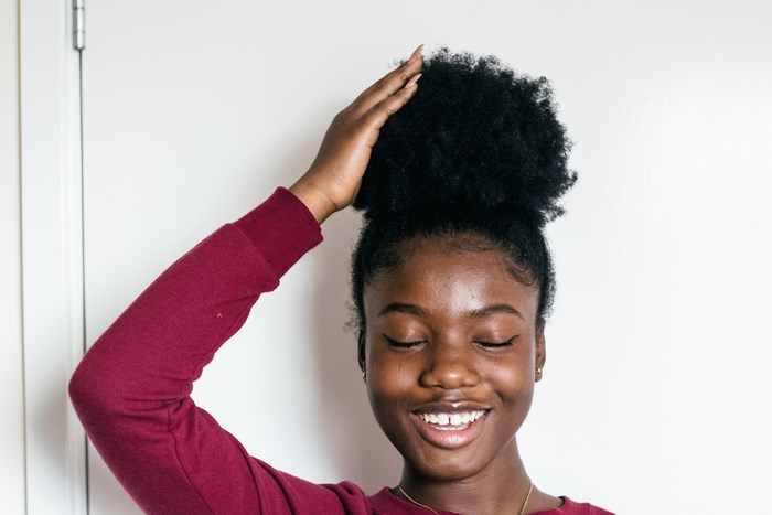 Young Black Woman with Afro Hair Smiling