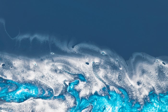 Abstract blue and white fluid art with dark blue background