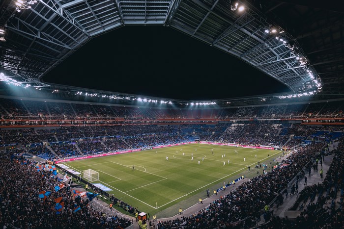 Soccer match at night in a stadium with a crowd