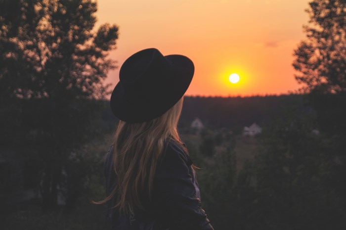 Woman in Fedora Watching Sunset Over Rubizhne