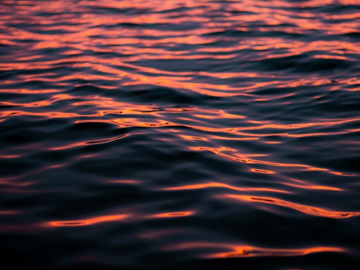 Water surface with sunset reflections