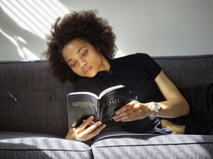 Woman reading a book on a couch