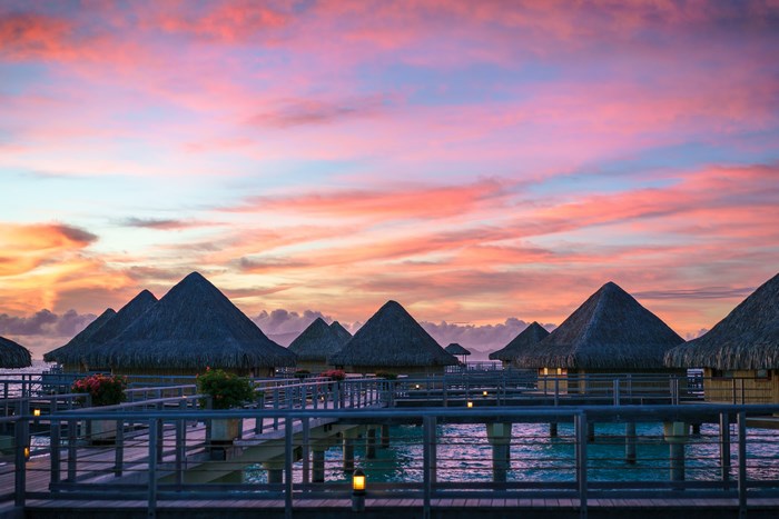 Overwater bungalows at sunset in Bora Bora