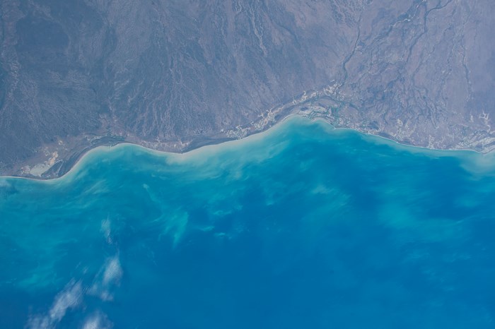 Aerial view of a coastline with turquoise ocean water