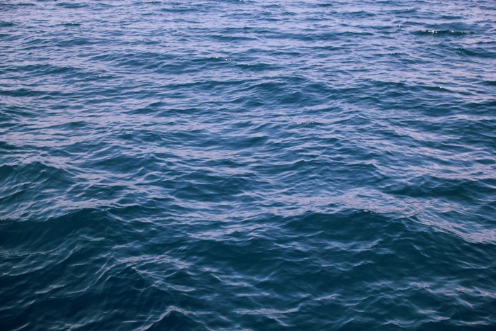 Deep blue ocean water with gentle waves